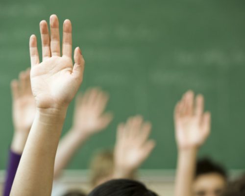 Hands raised in classroom